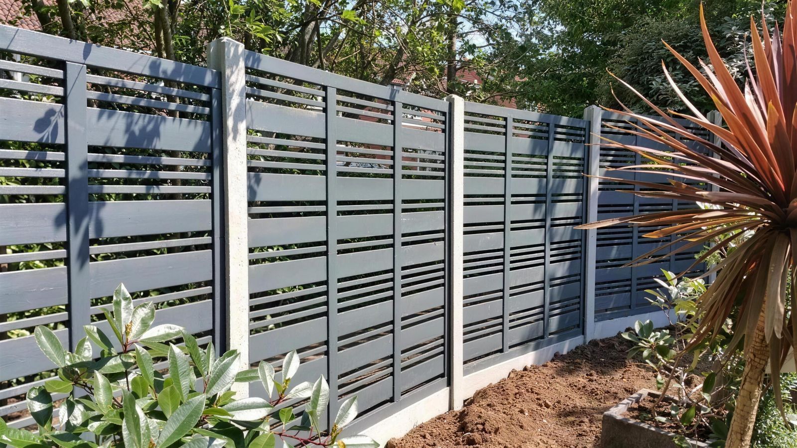 Grey slatted fence panels between concrete posts, installed by AWGS Fencing in Wokingham